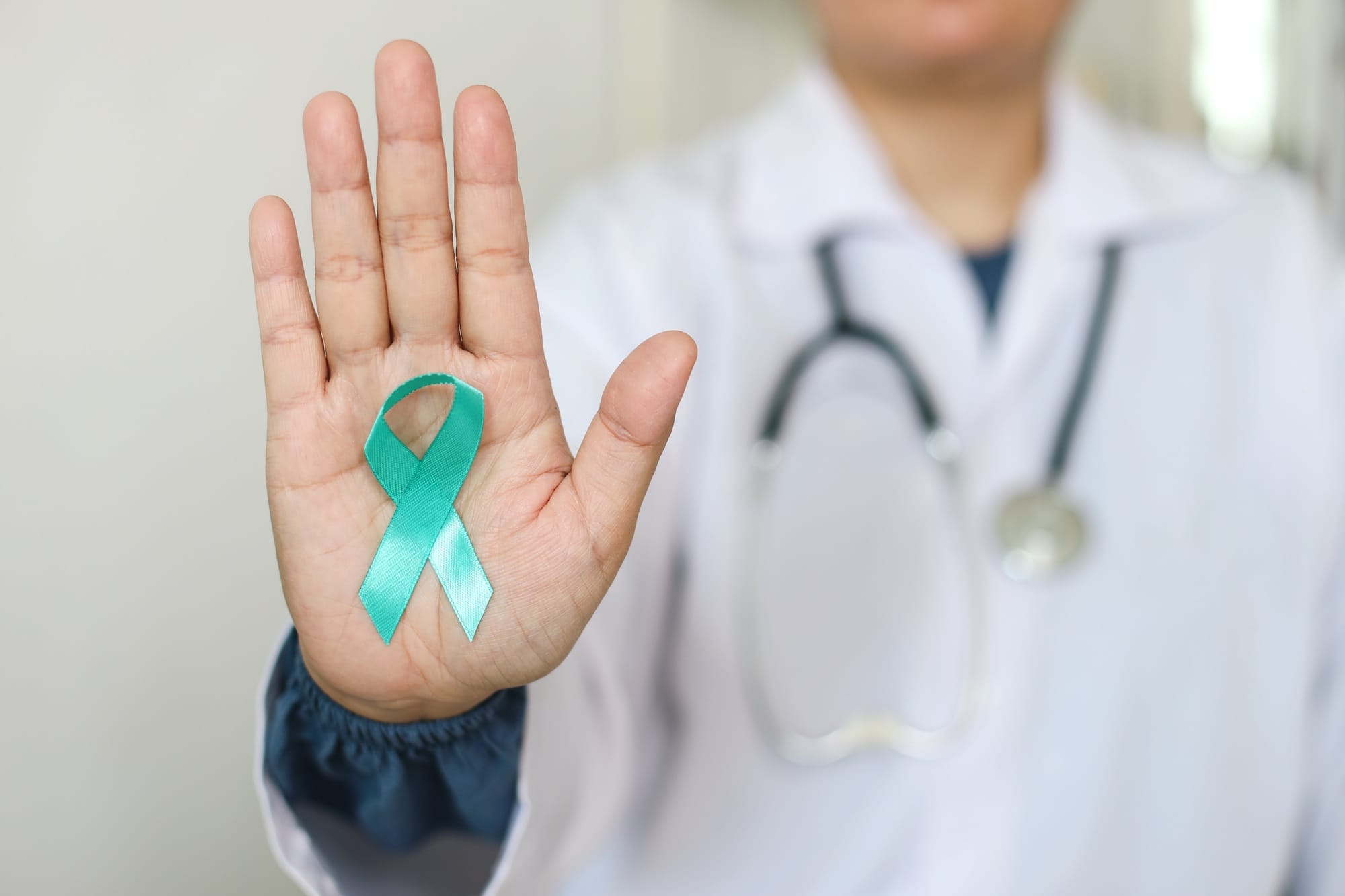 Doctor In White Coat With Teal And White Ribbon Awareness