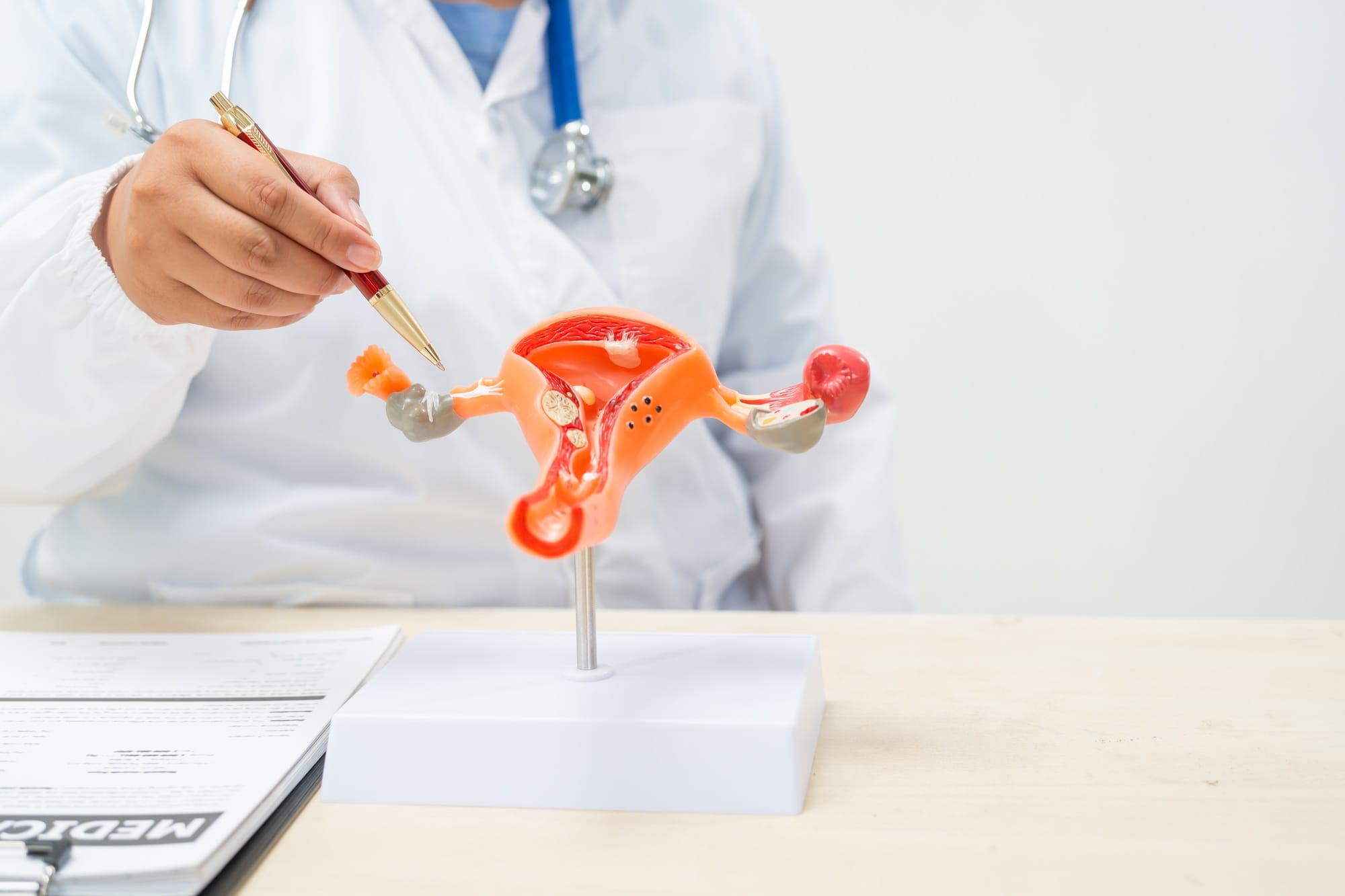 A female doctor sits at a desk in hospital explains about uterine conditions such as endometriosis