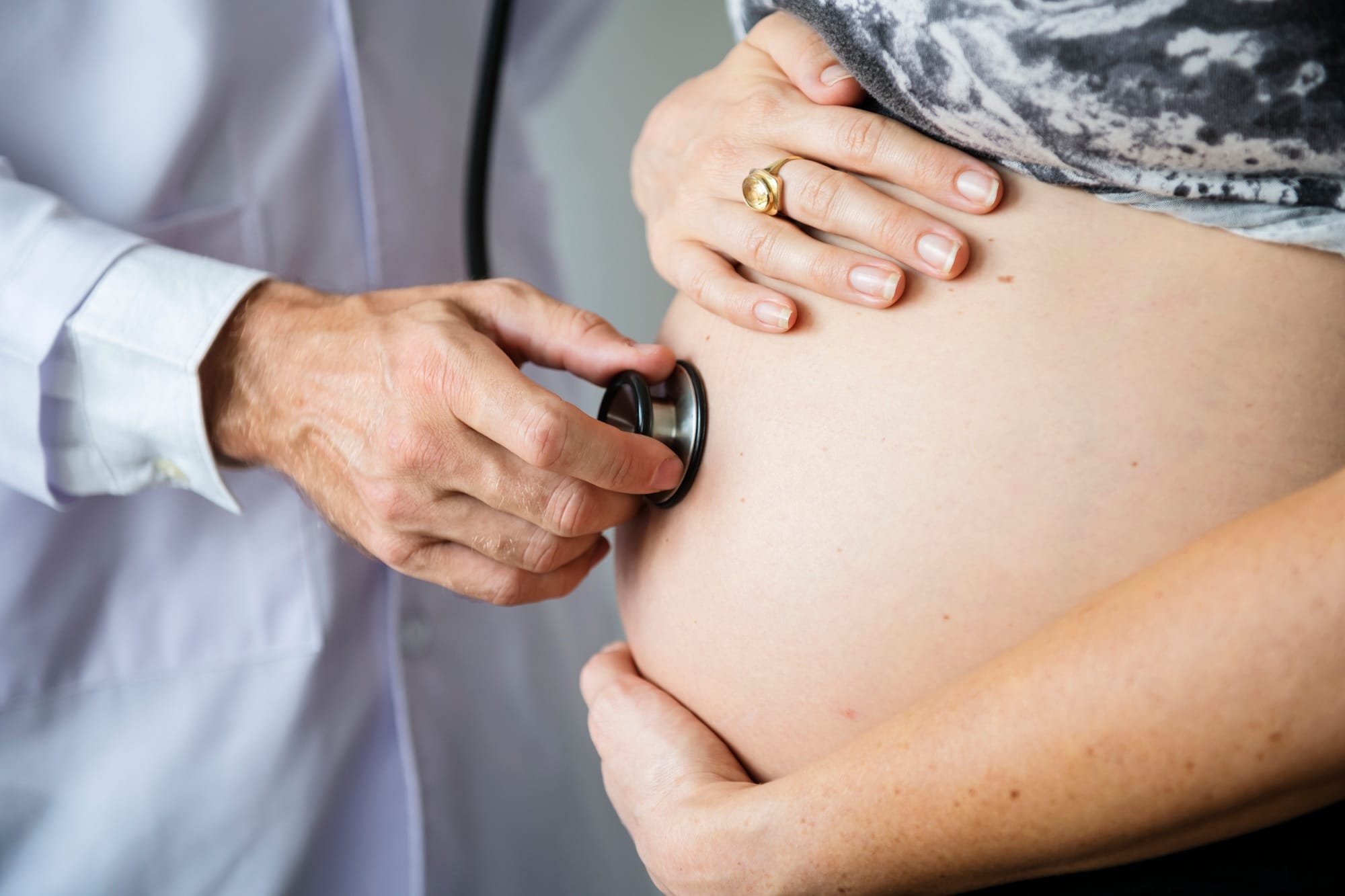 Pregnant woman having fetal monitoring by doctor